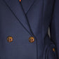 Close-up of the Blaze Milano First Class Charmer Blazer, a slim-fit deep navy piece with brown buttons, revealing a hint of an orange shirt underneath.