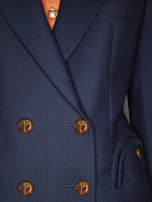 Close-up of the Blaze Milano First Class Charmer Blazer, a slim-fit deep navy piece with brown buttons, revealing a hint of an orange shirt underneath.