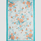 The Trailing Poppy Pareo by Erdem is a rectangular light blue silk-modal scarf featuring an orange and teal poppy print, teal border, and "FORUM" and "FÓRUM" in the corners.