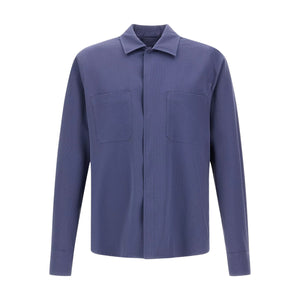 The Herno Seersucker Shirt Jacket is a long-sleeved, button-up style crafted in solid blue, featuring two chest pockets. Shown against a plain white background, this lightweight and versatile piece is ideal for effortless layering.