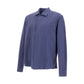 The Herno Seersucker Shirt Jacket features long sleeves, a button-up front, and a textured blue seersucker fabric. It includes a collar and two chest pockets, and is displayed against a plain white background. This lightweight design is breathable for all-day comfort.