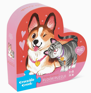 The Crocodile Creek Friends Furrever Puzzle is a heart-shaped, 36-piece floor puzzle for ages 3+, featuring an illustrated dog and cat with collars. Made from recycled cardboard.