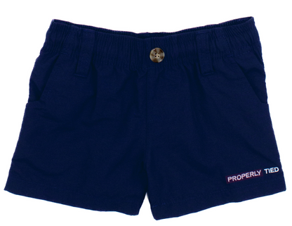 Properly Tied Boys' Mallard Short in navy blue for toddlers features an elastic waistband, side pockets, front button, moisture-wicking fabric, and "PROPERLY TIED" embroidered near the hem.
