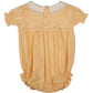 The Early Sunday Baby Girls' Martha Bubble romper showcases a timeless design with a Peter Pan collar, short puffy sleeves, and front buttons. It features a subtle dotted pattern for classic appeal.
