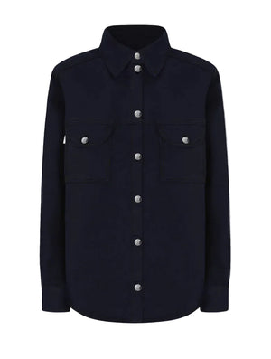 The Clapotis Berber Shirt by Blaze Milano is a long-sleeve, button-up black denim overshirt featuring a collar and two chest pockets with buttoned flaps, drawing on classic safari-style details for a timeless yet practical look.