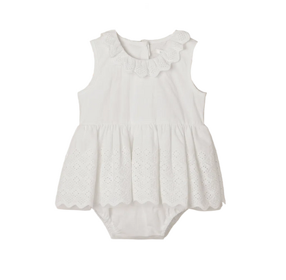 The Noralee Baby Girls’ Georgia Romper features a white sleeveless design with a scalloped collar and delicate eyelet detailing on the skirt, thoughtfully crafted for easy changing and presented against a plain white background.
