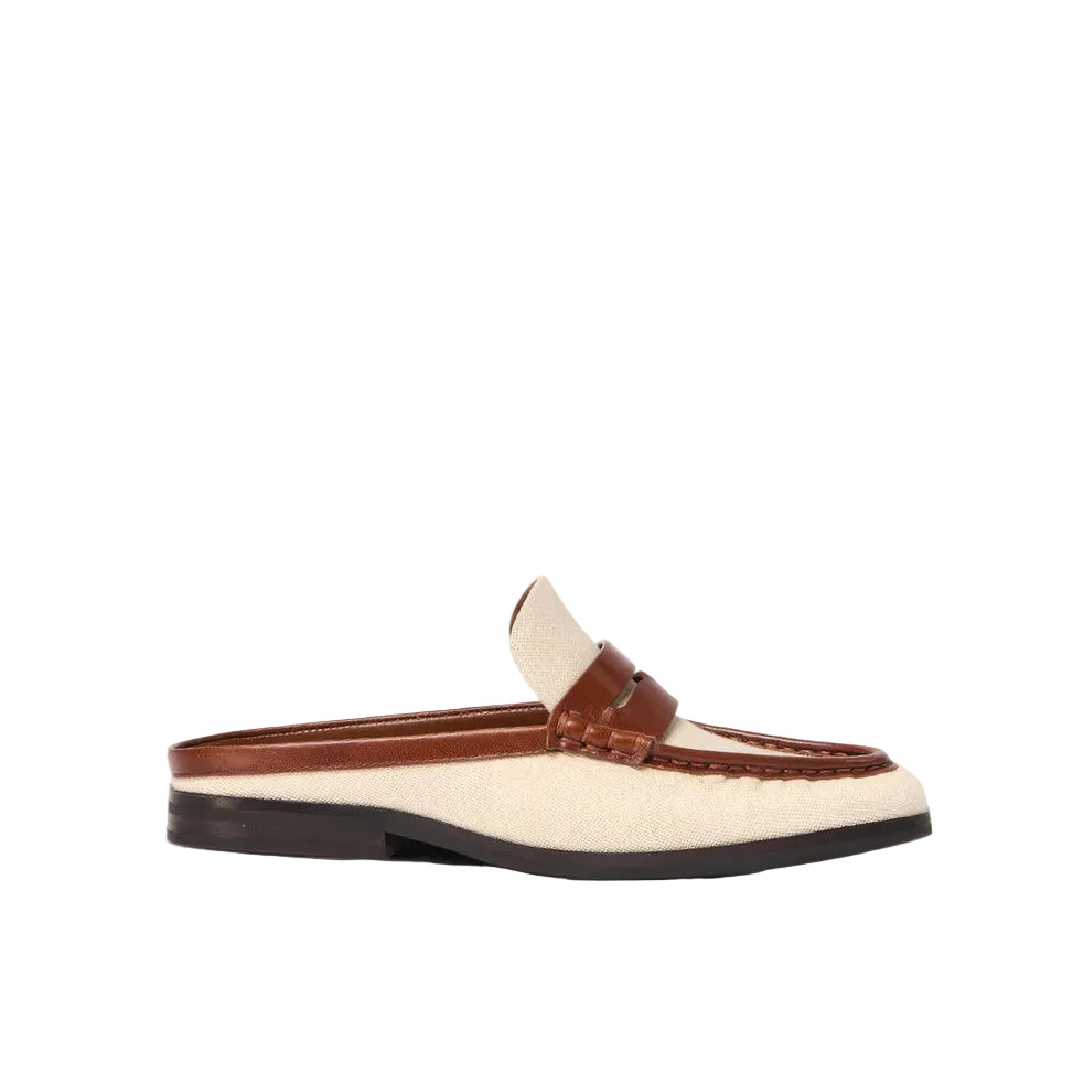 The Simkhai Dean Canvas Como Loafer Mule is a beige and brown backless slip-on loafer, crafted with a stitched leather upper and set on a low black sole, displayed against a white background.