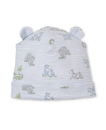 The Kissy Kissy Baby Safari Party Novelty Hat is crafted from light blue Pima cotton and features a charming safari party print with playful animal illustrations such as giraffes and zebras, along with two small fabric ears on top.