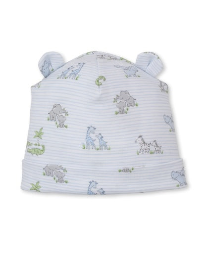 The Kissy Kissy Baby Safari Party Novelty Hat is crafted from light blue Pima cotton and features a charming safari party print with playful animal illustrations such as giraffes and zebras, along with two small fabric ears on top.