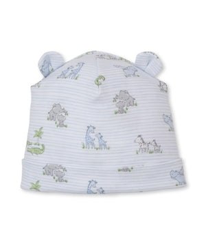 The Kissy Kissy Baby Safari Party Novelty Hat is crafted from light blue Pima cotton and features a charming safari party print with playful animal illustrations such as giraffes and zebras, along with two small fabric ears on top.