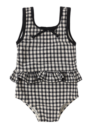 The Rylee & Cru Baby Girls' Skirted One-Piece features a black and white gingham print, a ruffle waist, and a small bow at the neckline. Displayed against a white background, this adorable romper blends classic style with comfort—perfect for pool days.