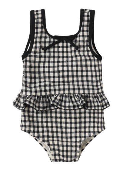 The Rylee & Cru Baby Girls' Skirted One-Piece features a black and white gingham print, a ruffle waist, and a small bow at the neckline. Displayed against a white background, this adorable romper blends classic style with comfort—perfect for pool days.