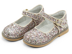 The L'Amour Natasha Glitter Mary Jane shoes by L'Amour Shoes feature a glittery pink and silver design with buckle straps and brown soles, ideal for adding a sparkle to any outfit.