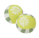 The Tides Out Citrus Skim Ball Set by Sunnylife includes two yellow and green striped fabric water bounce balls, each featuring "SUNNYLIFE" printed in white—perfect for endless fun as beach or pool toys.