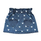 The Girls’ Teacher Skirt by Louis Louise features a playful blue denim design adorned with white heart prints and two oversized heart-shaped pockets on the front. Displayed against a white background, this charming A-line skirt adds a delightful touch to any girl’s outfit.