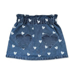 The Girls’ Teacher Skirt by Louis Louise features a playful blue denim design adorned with white heart prints and two oversized heart-shaped pockets on the front. Displayed against a white background, this charming A-line skirt adds a delightful touch to any girl’s outfit.