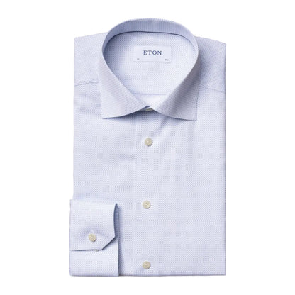 A Contemporary Geometric Print Poplin Shirt by Eton, featuring a spread collar and buttoned cuffs, with a subtle geometric pattern and expertly folded on a white background—a versatile wardrobe staple.