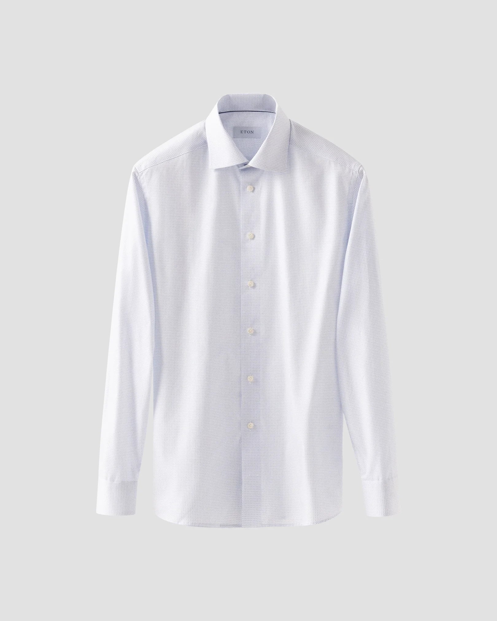 Displayed on a plain light gray background, the Contemporary Geometric Print Poplin Shirt by Eton features long sleeves, a collar, and a classic button-up design, offering a modern twist on a timeless wardrobe staple.