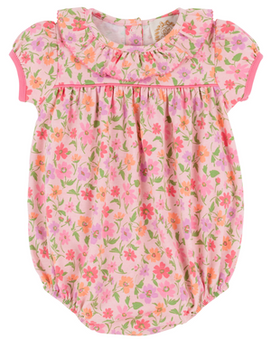 The Baby Girls' Pima Ramona Ruffle Bubble by The Beaufort Bonnet Company is a pink romper with short sleeves, a ruffled collar, and a Grand Cayman Gardens floral print in shades of pink, orange, and green.