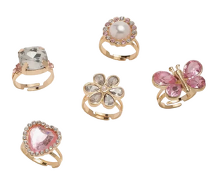 The Super Smalls Heartfelt Sparkle Ring Set includes five gold rings with a square clear stone, round pearl, flower, pink butterfly, and pink heart-shaped gem—ideal for Valentine’s Day or dress-up fun.