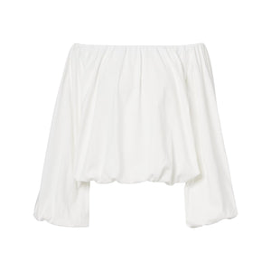 The Soft Volume Shirt by Dorothee Schumacher is a white cotton poplin off-shoulder top with long, loose sleeves, a gathered elastic neckline, and delicate gathered trims.