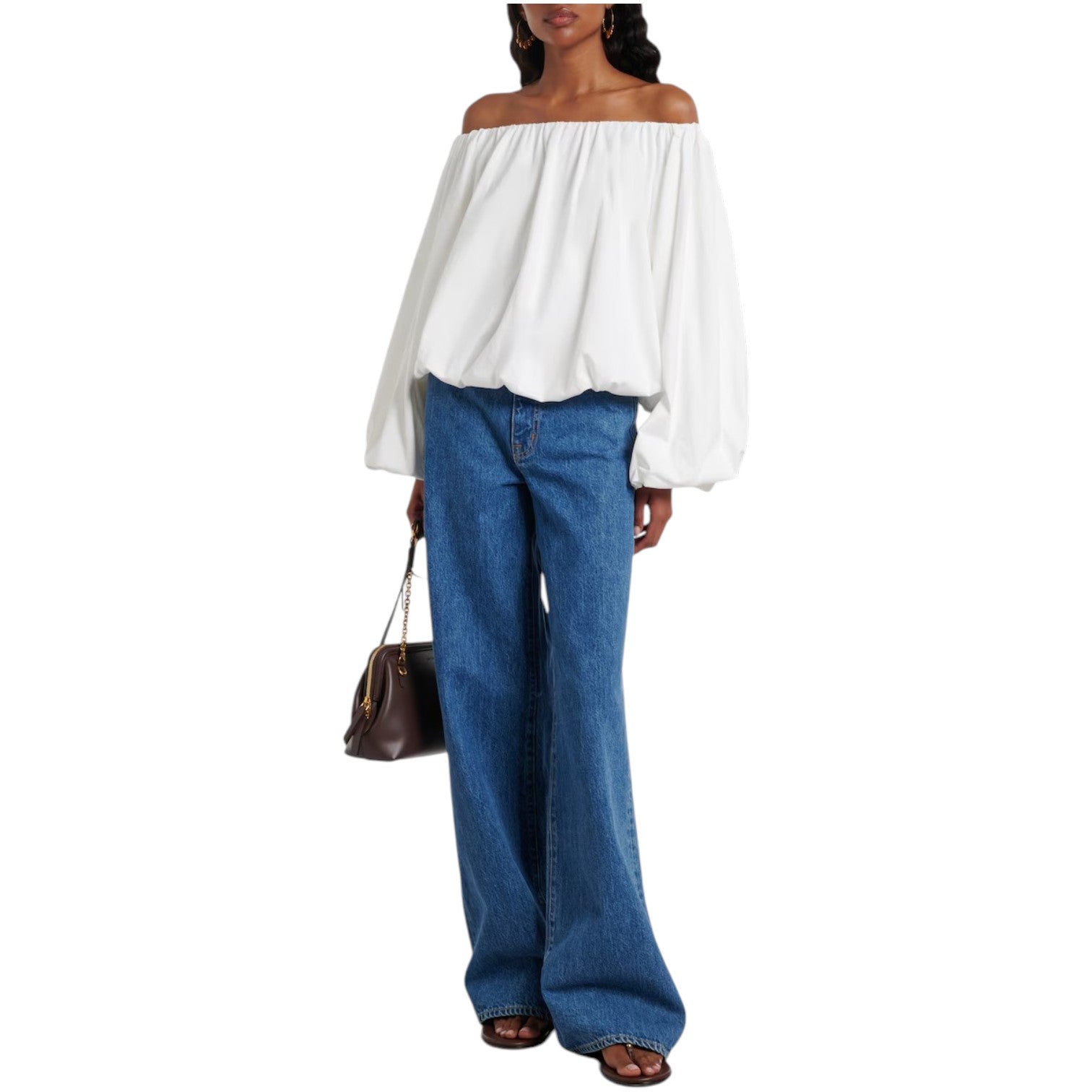 A person wearing the Dorothee Schumacher Soft Volume Shirt, wide-leg blue jeans, black sandals, and carrying a brown handbag.