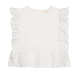 The Girls’ Esia Blouse by Louise Misha is a white cotton top featuring embroidered floral patterns, ruffled eyelet sleeves, delicate eyelet embroidery, a pleated hem, and a round neckline. The garment is displayed on a plain white background.