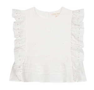 The Girls’ Esia Blouse by Louise Misha is a white cotton top featuring embroidered floral patterns, ruffled eyelet sleeves, delicate eyelet embroidery, a pleated hem, and a round neckline. The garment is displayed on a plain white background.