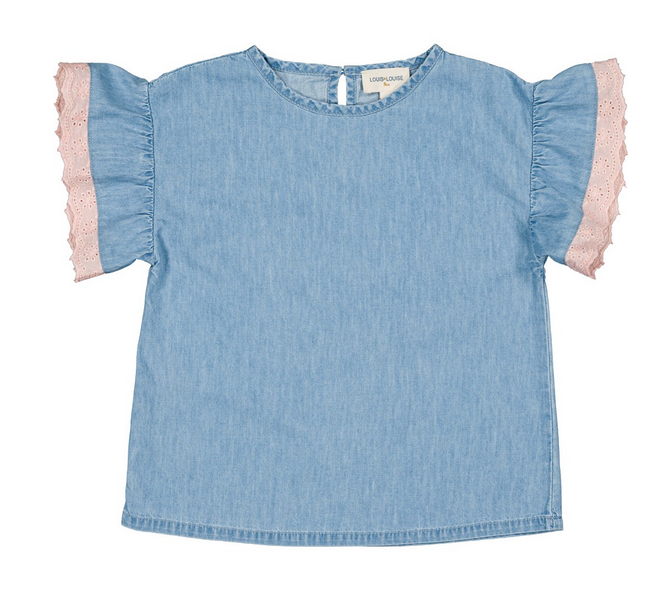 The Loli Chambray Tunic by Louis Louise is a light blue short-sleeve top with ruffled sleeves and pink lace trim along the edges, displayed laid flat on a white background.