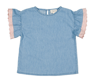 The Loli Chambray Tunic by Louis Louise is a light blue short-sleeve top with ruffled sleeves and pink lace trim along the edges, displayed laid flat on a white background.