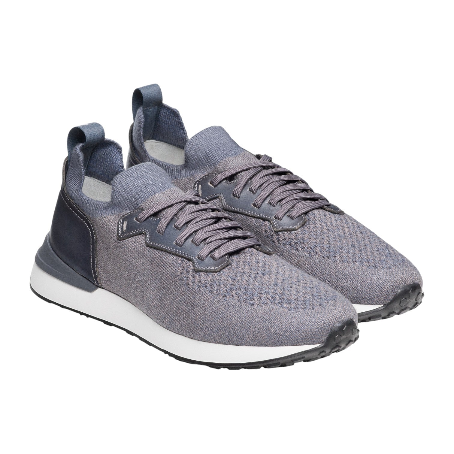 The Magnanni Stratus Sneaker is a gray knit pair with dark laces, cushioned footbeds, white midsoles, and black rubber sport soles, shown on a white background.