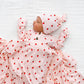 A newborn baby lies on a white blanket, dressed in the Lou Lou & Company Baby Girls’ and Girls’ Junie Top & Bottoms set, featuring a silky-soft strawberry print pattern.