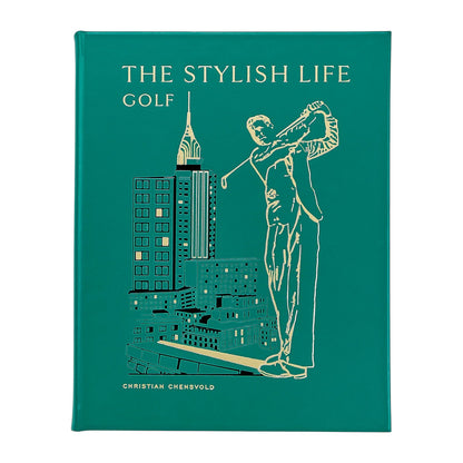 The Stylish Life: Golf" by Graphic Image is a green hardcover coffee table book, featuring a gold-outlined golfer and city buildings on the cover—an ideal gift for golf lovers.