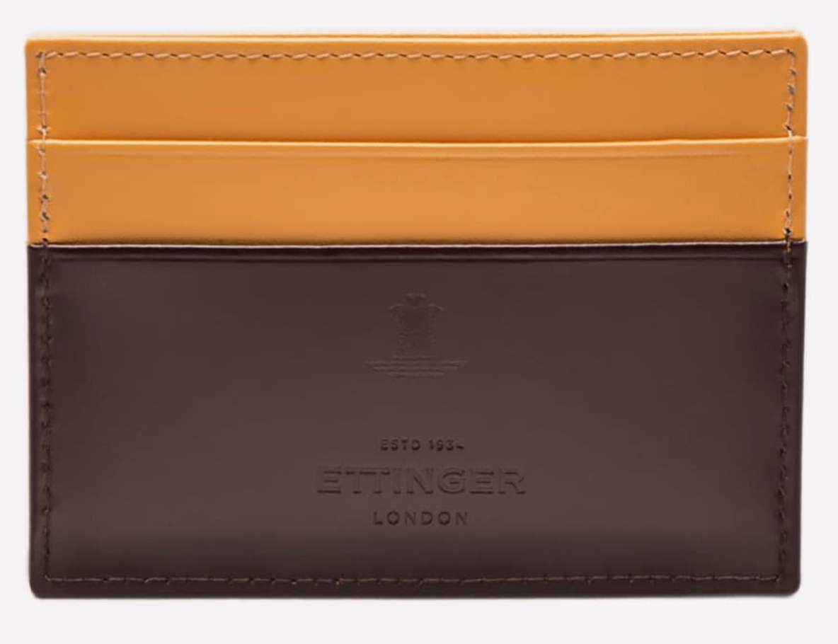 The Ettinger Bridle Flat Credit Card Case features two-tone yellow and dark brown bridle hide leather, the embossed Ettinger logo on the lower front, and multiple card pockets for easy organization.