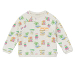Arsene & Les Pipelettes Boys' and Girls' Mini Coco Sweatshirt—an organic cotton, long-sleeve top for children with a vibrant Surf Camp print of huts, palm trees, and surfboards on a white background.