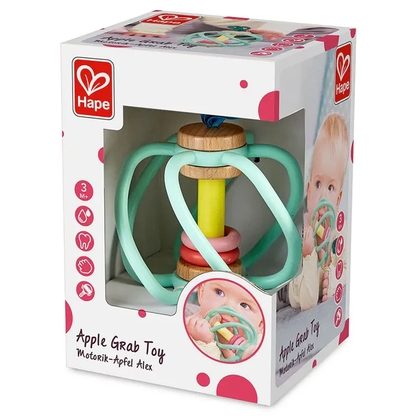 The Hape Apple Grab Toy is a boxed baby toy for ages 3 months+, featuring pastel rings and wooden teether parts, with product info and a baby photo displayed on the packaging.