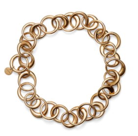 The Laura Necklace by Lie Studio is a bold gold-tone chain with chunky interlocking circular links, finished with a small round tag near the clasp for an elegant touch.