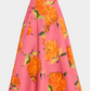 The Lela Rose Parker Floral Skirt is a high-waisted, A-line poplin skirt featuring a pink background with bold orange floral prints.
