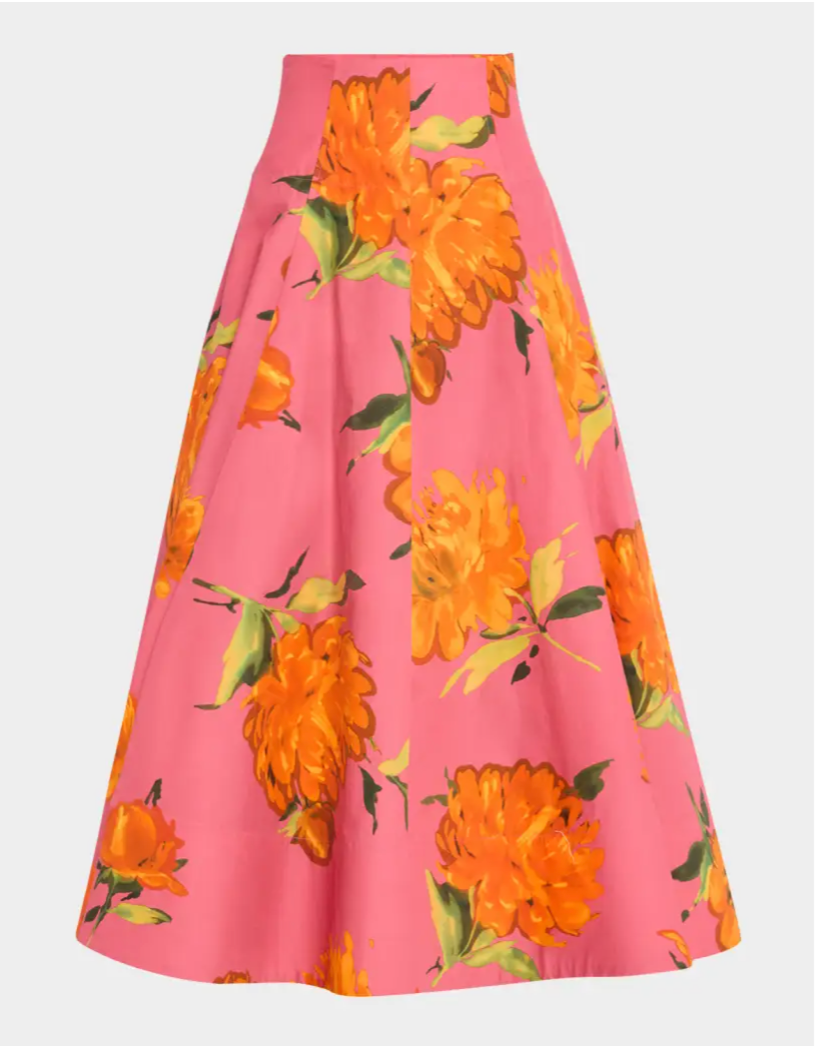 The Lela Rose Parker Floral Skirt is a high-waisted, A-line poplin skirt featuring a pink background with bold orange floral prints.