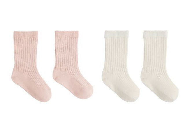 The Quincy Mae Socks Set includes two pairs of ribbed crew socks for children—one pair in light pink and one in off-white—presented side by side on a white background.