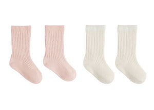 The Quincy Mae Socks Set includes two pairs of ribbed crew socks for children—one pair in light pink and one in off-white—presented side by side on a white background.