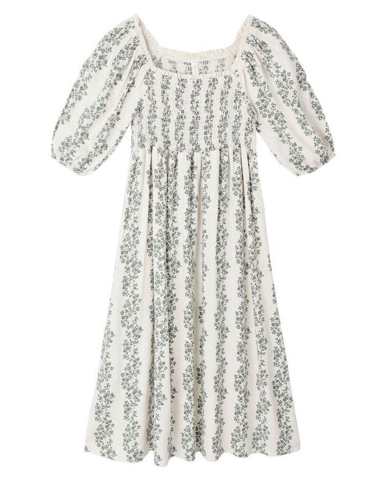 The Girls' Della Dress by Rylee & Cru is a white, ankle-length dress with puffed sleeves, a gathered bodice, vertical green floral print, and delicate crochet trim.