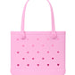 A light pink Baby Bogg® Bag by Bogg Bags, featuring small heart-shaped cutouts and two handles, crafted from a flexible, washable material and displayed against a white background.