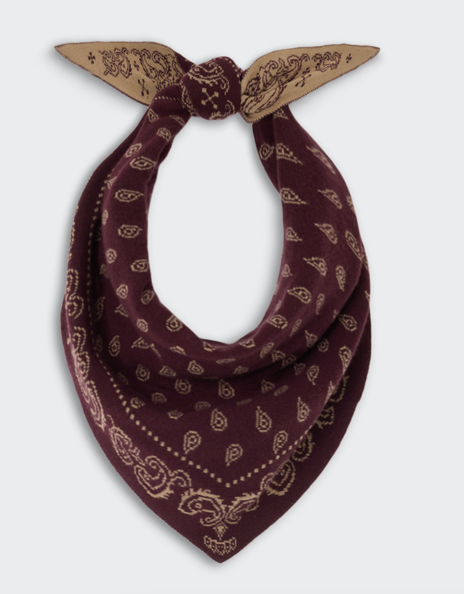 The Wild Rag by Guest in Residence is a maroon cotton-silk bandana featuring a beige paisley pattern, styled in a loose knot against a plain background. This best-selling accessory brings effortless elegance to any ensemble.