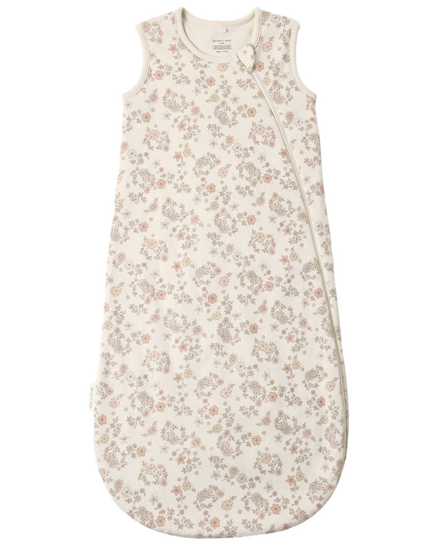 Quincy Mae Baby Jersey Sleep Bag—crafted from soft organic brushed cotton, this sleeveless sleep sack features a white background adorned with a light brown floral pattern and includes a convenient side zipper.
