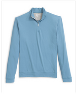 The Motion Performance 1/4 Zip by Johnnie-O in light blue features long sleeves, a stand-up collar, cuffed sleeves, and a zippered closure. Displayed against a plain white background, this versatile pullover combines the breathability of performance polos with the refined look of an office-ready golf shirt.