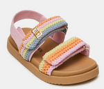 The Steve Madden Kids Toddlers’ Mona Sandal features a tan sole, pink strap, and multicolor crocheted bands in pink, orange, yellow, and blue with gold buckles—a charming slingback sandal designed for little feet.