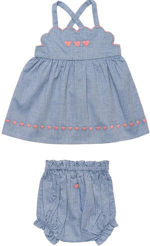 The Baby Girls’ Alice Baby Dress & Bloomer Set from Early Sunday features a charming blue sleeveless dress crafted from soft cotton chambray, beautifully accented with delicate pink heart embroidery. The delightful set includes matching bloomers with an elastic waistband and a sweet pink heart detail.