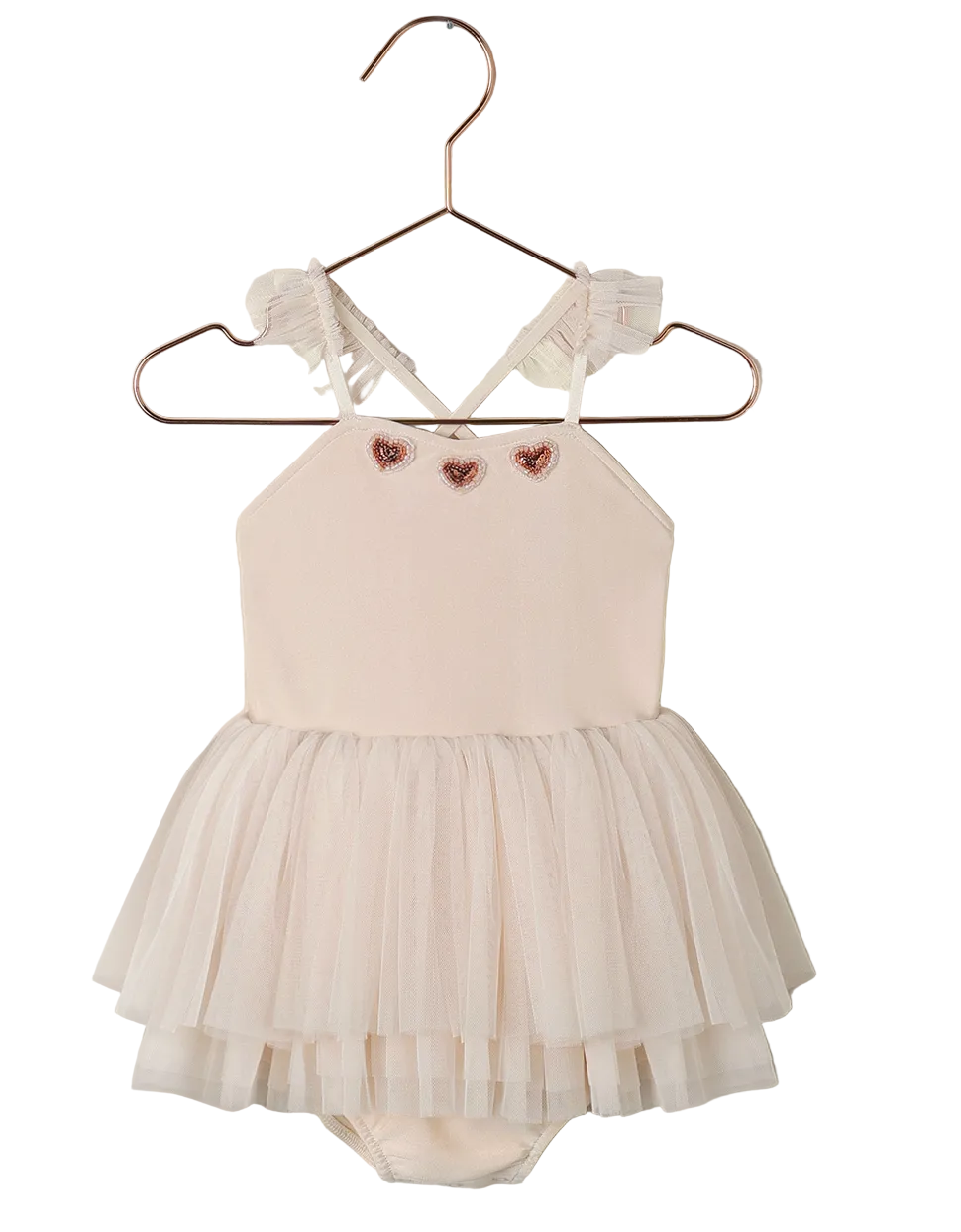 The Noralee Baby Girls' & Girls' Clementine Tutu is a cream-colored dress with ruffled straps, pink heart accents on the chest, and a layered tulle skirt, shown on a hanger.