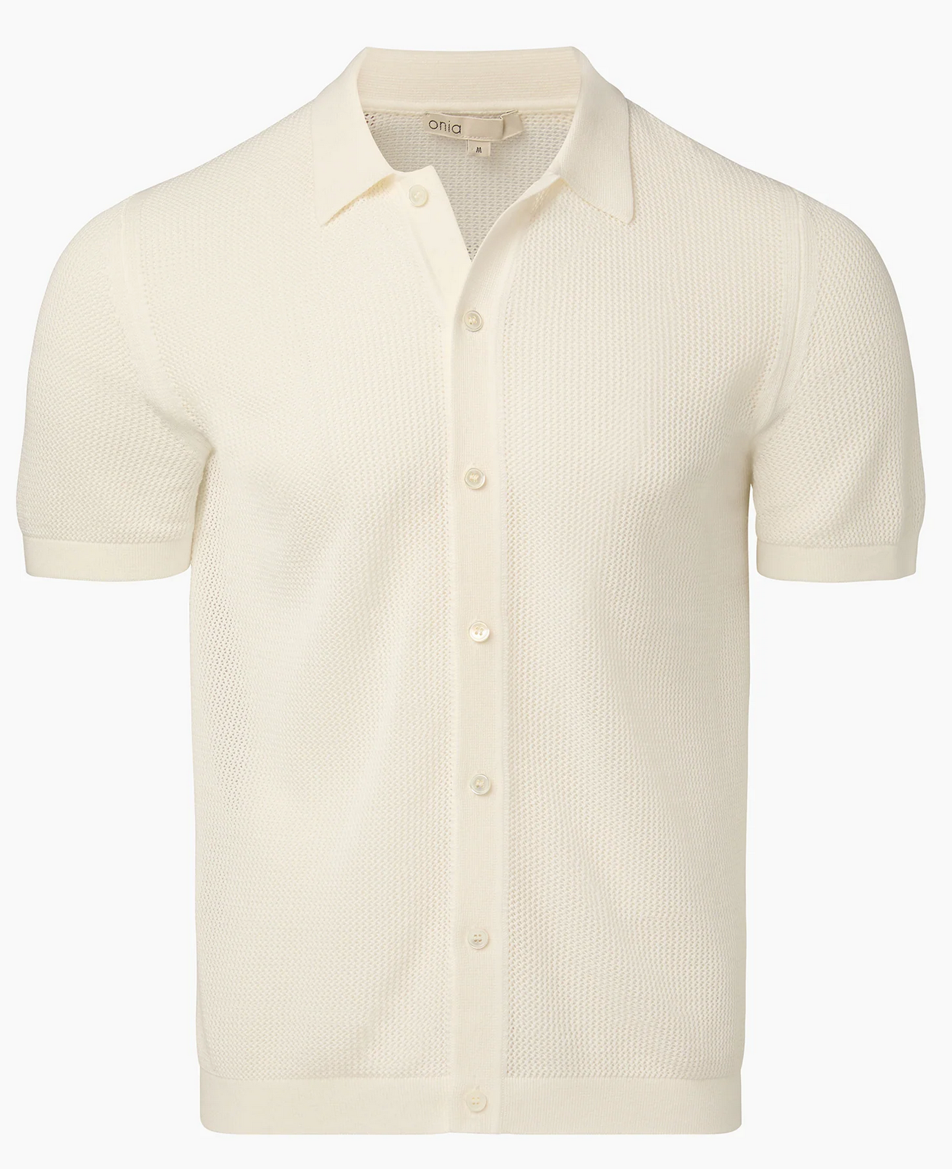 The Onia Crochet Knit Button Up is a cream short-sleeve shirt made from crochet cotton yarn, featuring a collar and button-up front—ideal for layering in warm weather. Shown against a plain white background.